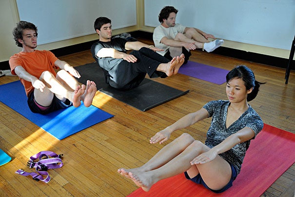 Yoga class with Shaomin Chew '13 (front) in the Lowell House Tower room. Eli Martin '13 (from left), Jerry Tullo '12, and Johnny Motley '12 follow Chew's lead.