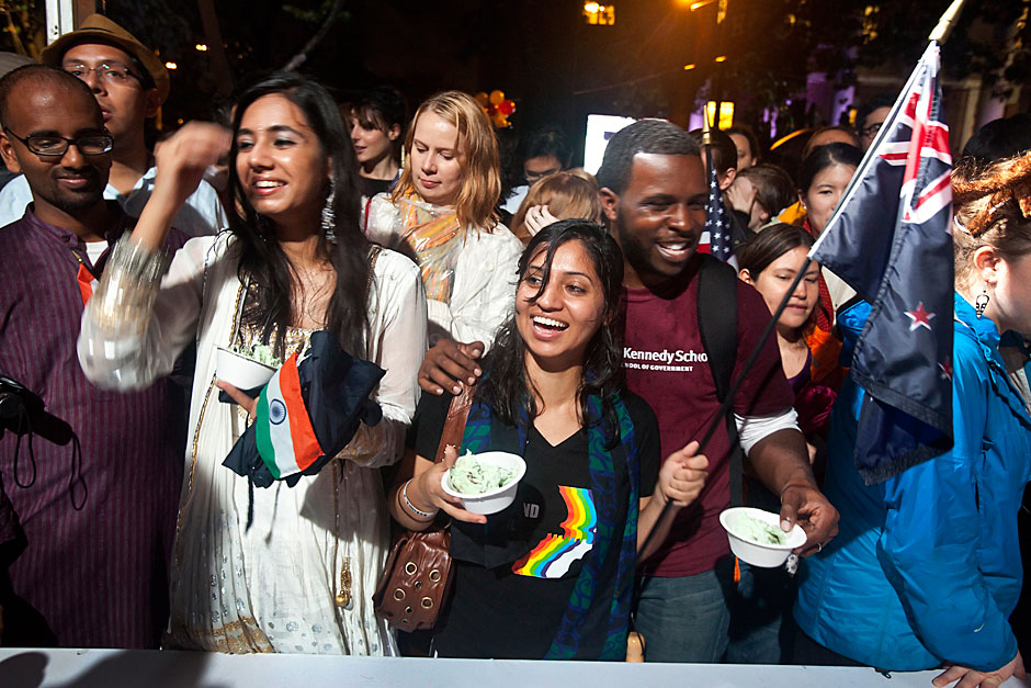 Jasdeep Randhawa '13 (left) and Divya Dhar '13 (center) are all smiles as they finally get served ice cream after a long wait during Harvard's 375th anniversary celebration in Tercentenary Theatre. Jon Chase/Harvard Staff Photographer