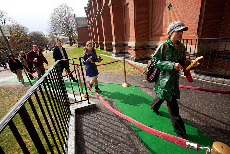 Emma Beaumont-Smith (from center) and her mother, Natalie Beaumont-Smith (green jacket) of the Office of Work/Life Resources, enter the 2012 Green Carpet Awards inside Sanders Theatre. Kris Snibbe/Harvard Staff Photographer