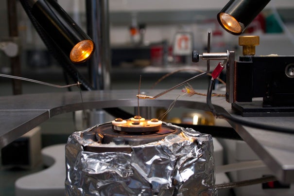 Shriram Ramanathan's laboratory setup for testing solid-oxide fuel cells. The fuel cell is hidden under the circular component at the top, which pins it down to create a tight seal with the hydrogen fuel entering from below. Two needles connect with the electrodes to measure the electricity produced. 