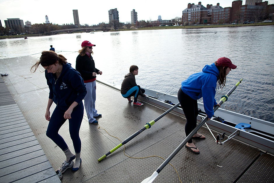 Eliot House residents who participate in the Eliot Boat Club, the intramural crew program, arrive at the boat house launch along the Charles River. Members of a women's team, including Caroline Cox '14 (from left), Brianne Corcoran, Zuzanna Wojcieszak, and Elizabeth Fryman '12, board the scull before heading out on the water. Stephanie Mitchell/Harvard Staff Photographer