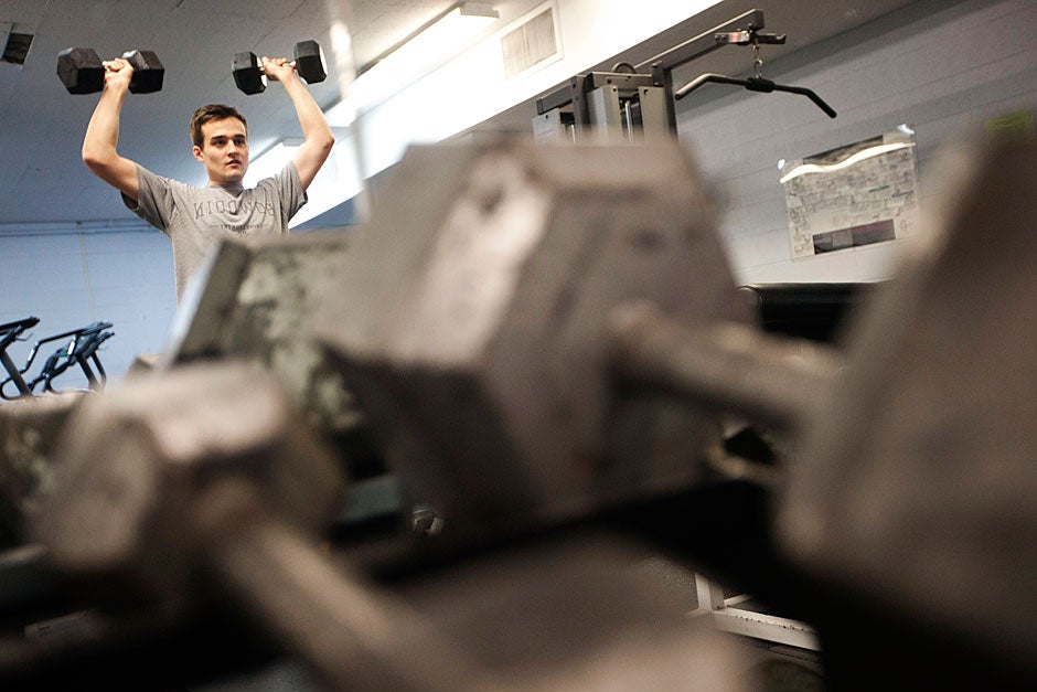 Nicholas Galat '13 works out in the fitness room inside Quincy House. Kris Snibbe/Harvard Staff Photographer