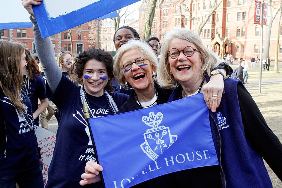 Lowell House Masters Dorothy Austin (center) and Diana Eck (right) are joined by Ellie Brinkley ’13 as they display a House flag on Housing Day in Harvard Yard. Jon Chase/Harvard Staff Photographer