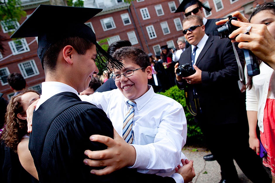 Eliot House graduate Oscar Zarate ’12 is congratulated by his family after he receives his degree on Commencement Day. Stephanie Mitchell/Harvard Staff Photographer