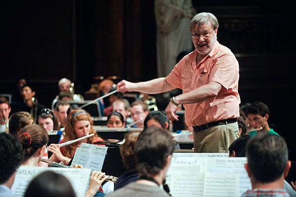 Tom Everett, director of bands at Harvard, takes the Harvard Summer Pops Band through its paces at Sanders Theatre. The band is celebrating its 40th anniversary with a concert in Harvard Yard on July 26.