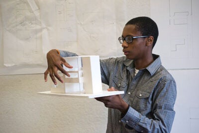 Patrick Joseph shows the model he made of a residential building that doubles as an art studio. His design was made during Project Link, a four-week program that immerses 10th- through 12th-grade students from Greater Boston in the world of design. Since Project Link’s inception, program leaders have targeted regional high schools that don’t have art or architecture programs.