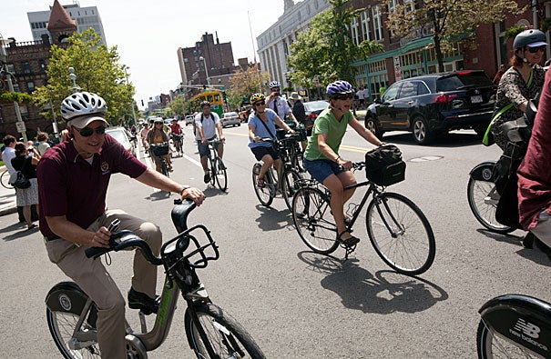 Associate Director of Harvard University Parking Services Jim Sarafin (far left) rides with a train of bicyclists today as part of the Hubway bike-share program. The program has been expanded to include more nearby communities.
