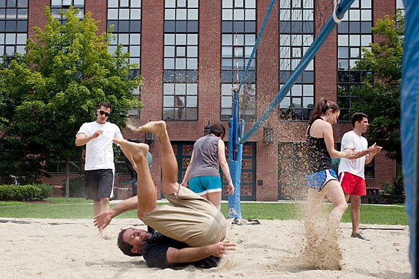 Nick Kuperwasser somersaults in the sand after making the shot at the summer Rhino Cup volleyball game. The annual Rhino Cup volleyball league stokes the competitive fires of Harvard’s biological community, drawing researchers out of the lab and onto the sandy volleyball court at the Biological Laboratories. The finals are Aug. 29.