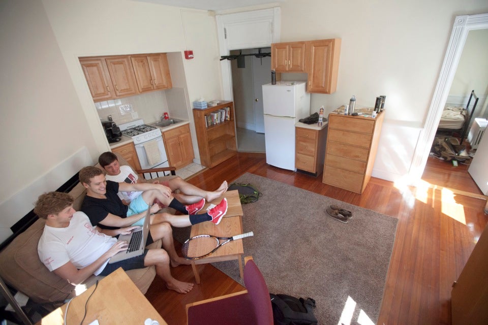 Kyle McIntee `15, (from left), Chuck Katis `15, and Matt Karle `15, who are now living in adjacent rooms in Fairfax Hall swing housing, reunite after the summer.
