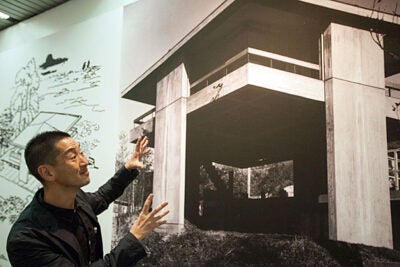 Guest curator Ken Tadashi Oshima points out the elements that make Sky House unique. Its open, flexible floor plan — with verandas on all four sides — recalls the style of traditional Japanese interiors. The image is part of "Tectonic Visions Between Land and Sea," a room-filling, eye-filling exhibit at Gund Hall.