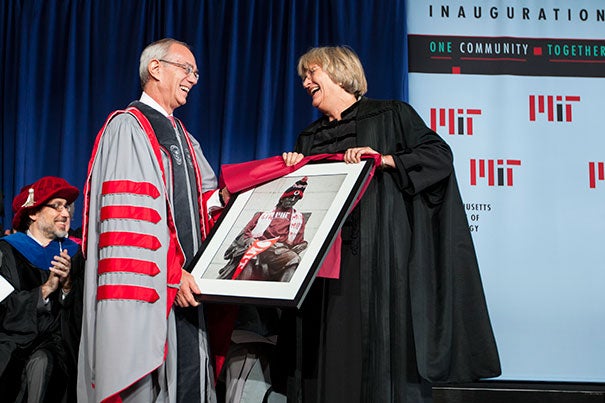 During the Inauguration of L. Rafael Reif (left), the 17th president of the Massachusetts Institute of Technology, Harvard President Drew Faust presented Reif with a framed photo of the John Harvard Statue decorated in MIT gear.