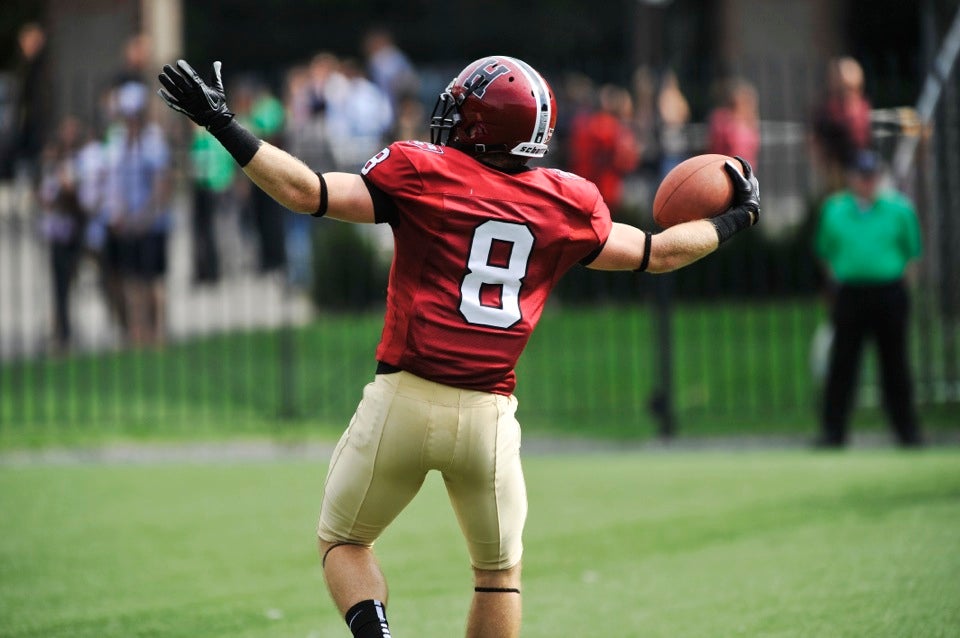 Crimson wide receiver Andrew Berg `14 celebrates the first of his three TD catches during the first half.  Berg tied the Harvard record for most TD catches by a player in a game.