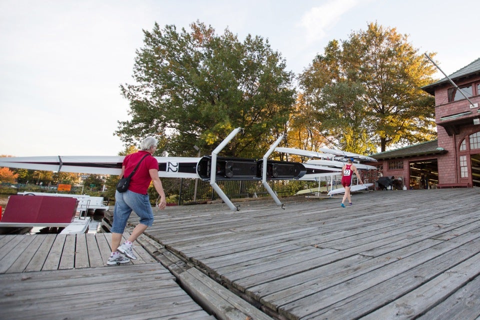 Kathryn Keeler assists daughter Abigail with loading the boat back into the boathouse.
