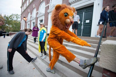 Dudley Athletics Fellow Seth Peabody incorporated Halloween into the Wednesday Harvard On The Move run as he stretched his paws before hitting the pavement.
