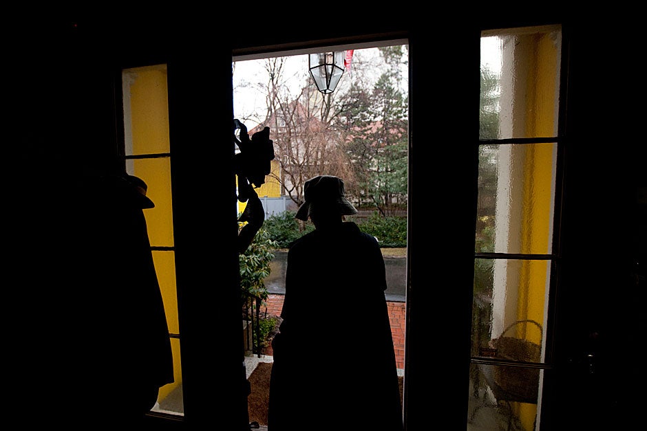 Jan Randolph, the longtime assistant to the late Rev. Peter J. Gomes, passes by a black ribbon hung in Gomes’ memory on the door of Sparks House. Kris Snibbe/Harvard Staff Photographer