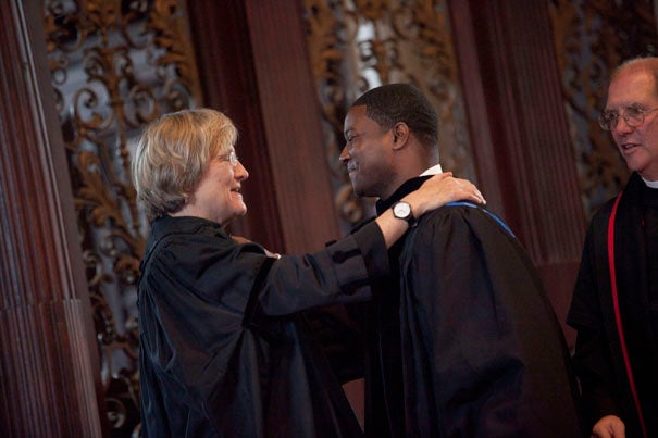 Harvard President Drew Faust installs the Rev. Jonathan Walton as Pusey Minister in the Memorial Church and Plummer Professor of Christian Morals, while the Rev. Wendel "Tad" Meyer looks on.