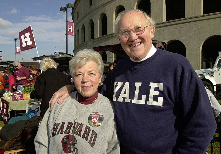 Dottie Balkema (left) and Milt Minkema display their divided loyalties before The Game in 2004. Dottie's grandson Robert Balkema '06 played linebacker for the Crimson, while Milt's son is a professor at Yale. Dottie and Milt are old friends who now see each other regularly after being married to different spouses. They first dated 50 years ago in high school. 