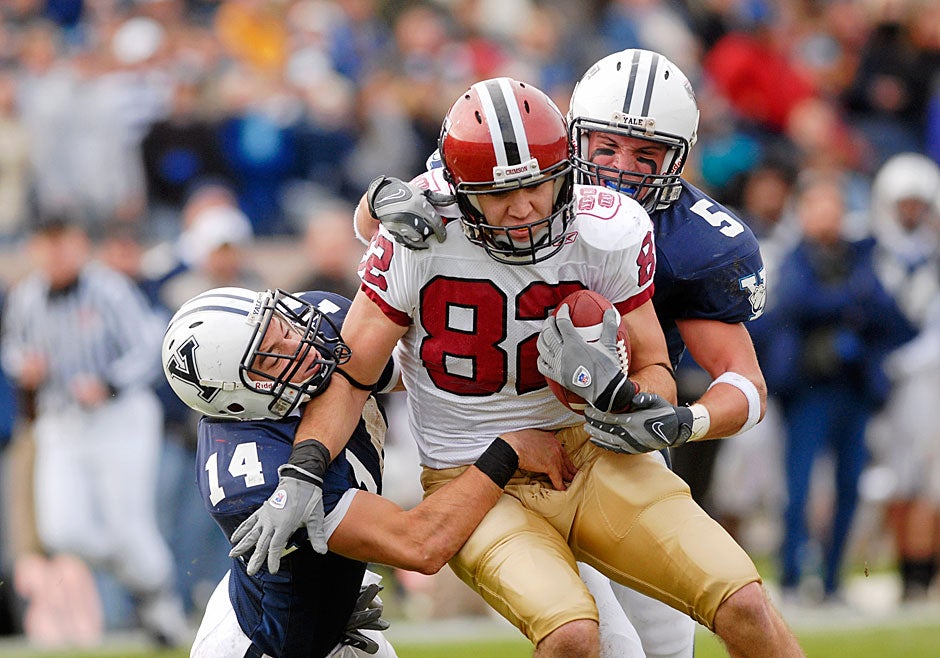Harvard wide receiver Matt Luft '10 gets wrapped up by Yale defenders Steven Santoro (left) and Paul Rice after a long pass reception. Luft scored two touchdowns and garnered eight passes for 160 yards, as Harvard defeated their rivals, 37-6, in 2007. 