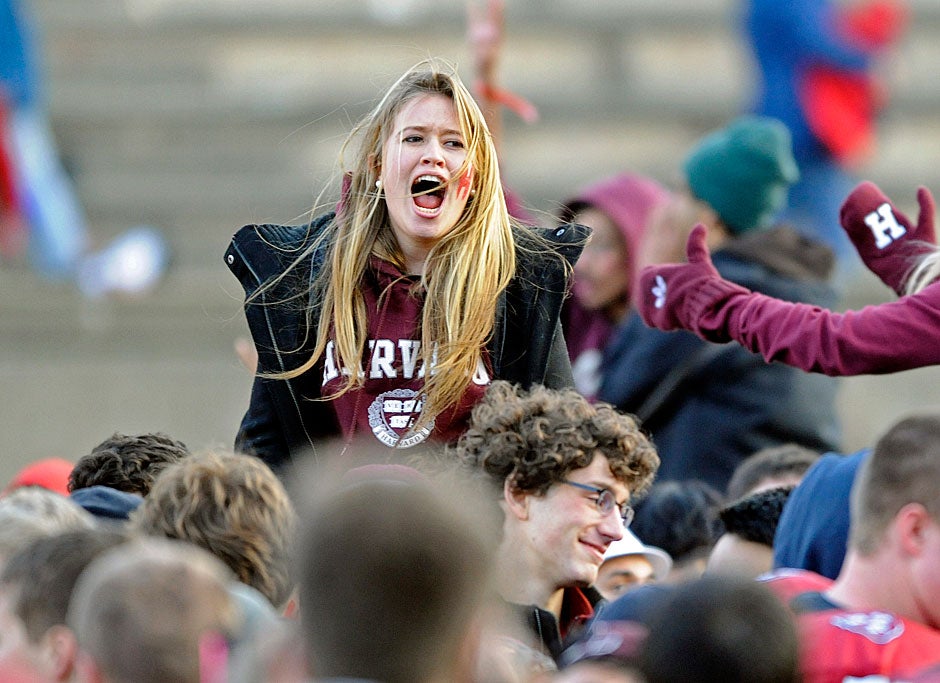 A Crimson fan riding a wave of ecstatic students on the field shrieks out in jubilation as Harvard defeats Yale, 28-21, in 2010. 