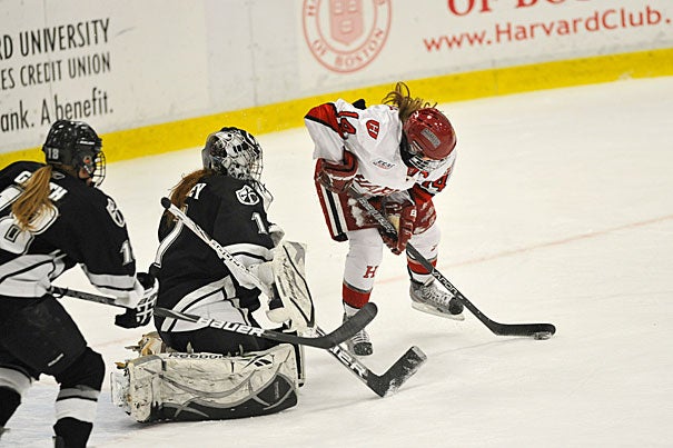 Co-captain Jillian Dempsey '13 maneuvers for a shot on goal as Providence College's goalie comes out of the crease. Dempsey finished with four goals to extend her point streak to 24 games. Harvard won, 8-1.