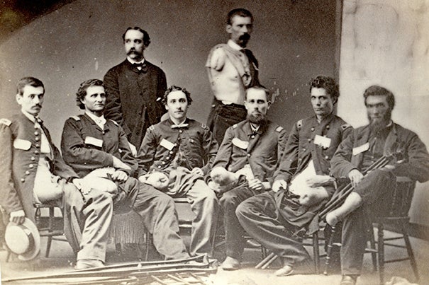 Here is a group of officers who have undergone amputations for gunshot injuries, as published in "Photographs of surgical cases and specimens / prepared by direction of the Surgeon General by George A. Otis." 