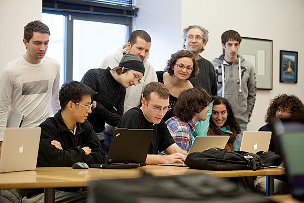 David Fan and Bob Adolf (left and center, seated at laptops) were second-place finishers in the IACS Computational Challenge.  For the final challenge, students were tasked with designing a program to play foosball. 