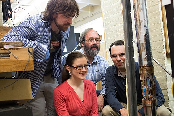 Mason Marshall '16 (from left), Kathryn Marable '16, George Vasmer Leverett Professor of Physics Gerald Gabrielse, and Jack DiSciacca '13 have measured the magnetic charge of single particles of matter and antimatter with unprecedented precision.