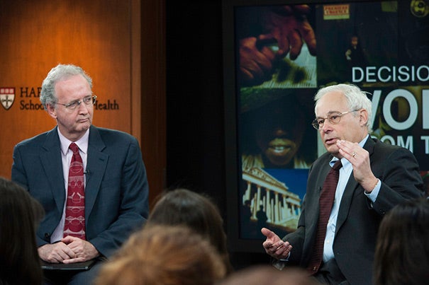 “You can’t ask a kid to be healthy and exercise if he can’t safely stand on the front porch, never mind run down the street,” said Donald Berwick (right), a lecturer at Harvard Medical School. His talk was sponsored by the Harvard School of Public Health’s Voices from the Field program, and was hosted by John McDonough (left), professor of the practice of public health.