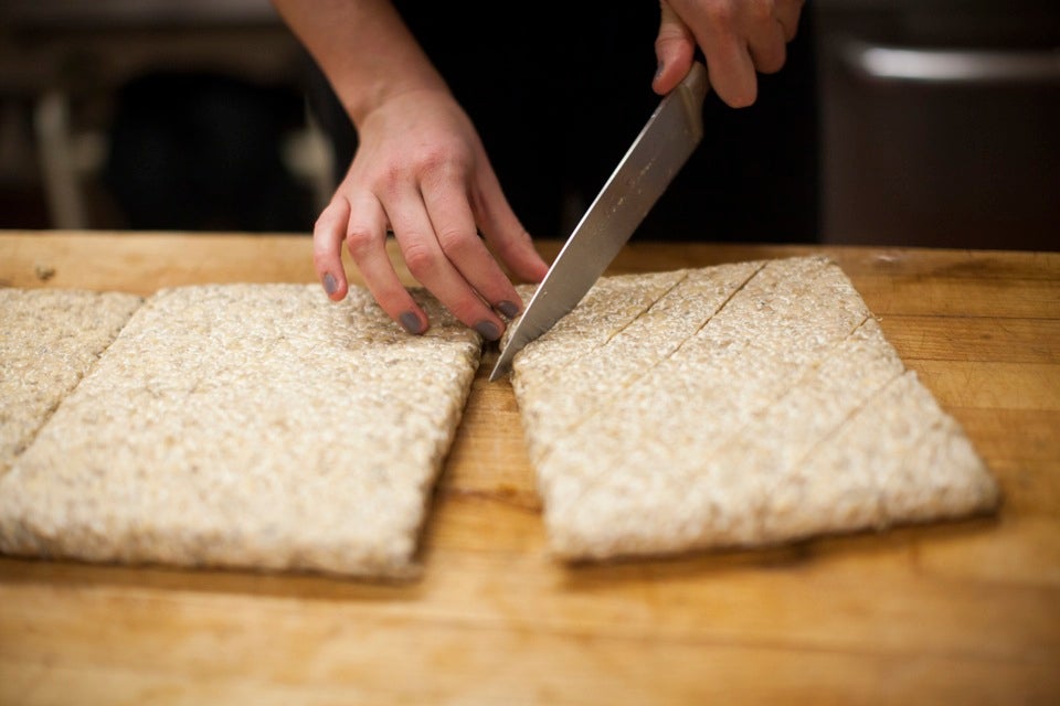Zoe Tucker '13, one of the two co-op presidents, prepares tempeh, slicing the whole soybean slabs into rhombus-shaped pieces. She then marinates them with soy sauce and maple syrup before grilling.