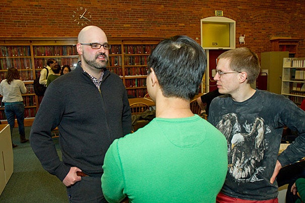 Harvard graduate and physics major Michelangelo D'Agostino (left) gives graduate students Yat Shan Au and Tom Dimiduk an overview of the wide-ranging role that data analytics played in Obama's presidential campaign. 