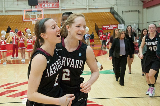 Crimson players Elle Hagedorn '13 (left) and  Melissa Mullins '14 celebrate after their 61-57 win over Hartford. Hagedorn scored Harvard's last basket of the game to seal the victory for the Crimson. 