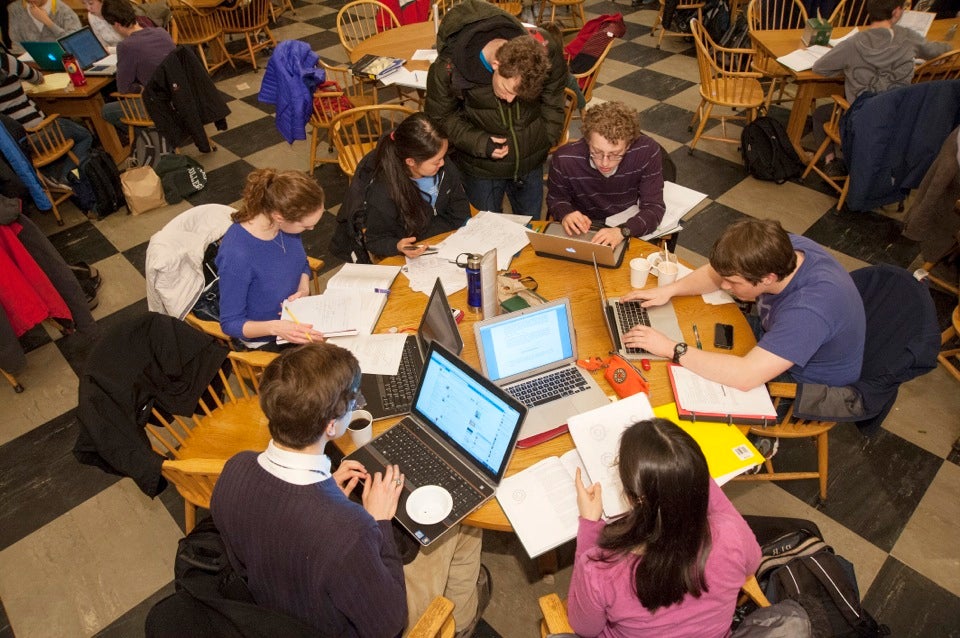 At Leverett House Physics Night, students gather around tables in the dining room to work on physics projects.