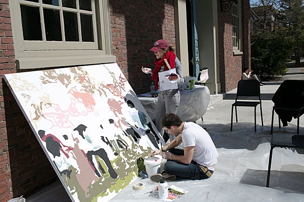 Artist Diana Gilon (standing) works with Gary Carlson '13 on a mural.