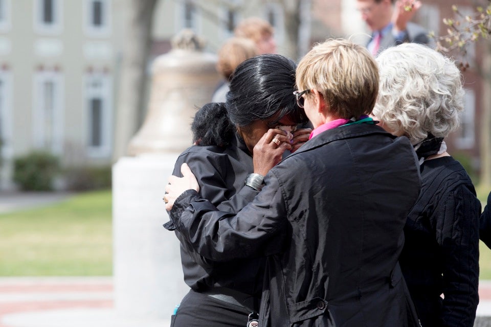Claire Aly (left) cries for her co-worker Patty Campbell, whose daughter was killed in the attacks.
