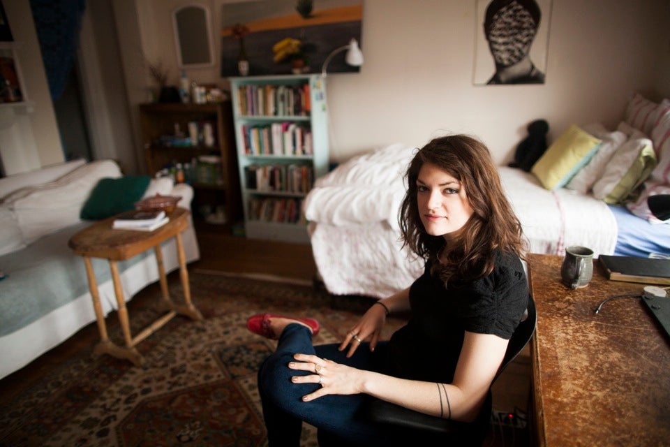 Charlotte Lieberman ’13, an English concentrator, is a native of New York City. Her room is decorated with books, posters, and album covers — a “strange mix of things that are sentimental and things that are kind of cheeky.” Charlotte is seated at her desk, where she writes a lot of poetry before she goes to sleep.