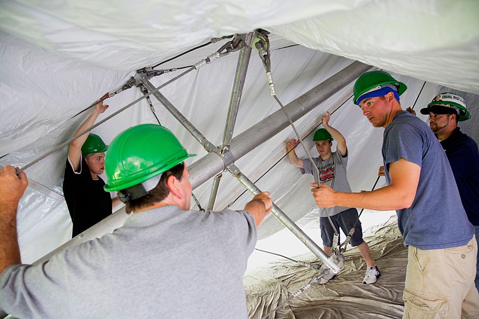 Workers from the William Blanchard Co. in Wakefield, Mass., raise the tent for Commencement inside Tercentenary Theatre. Kris Snibbe/Harvard Staff Photographer