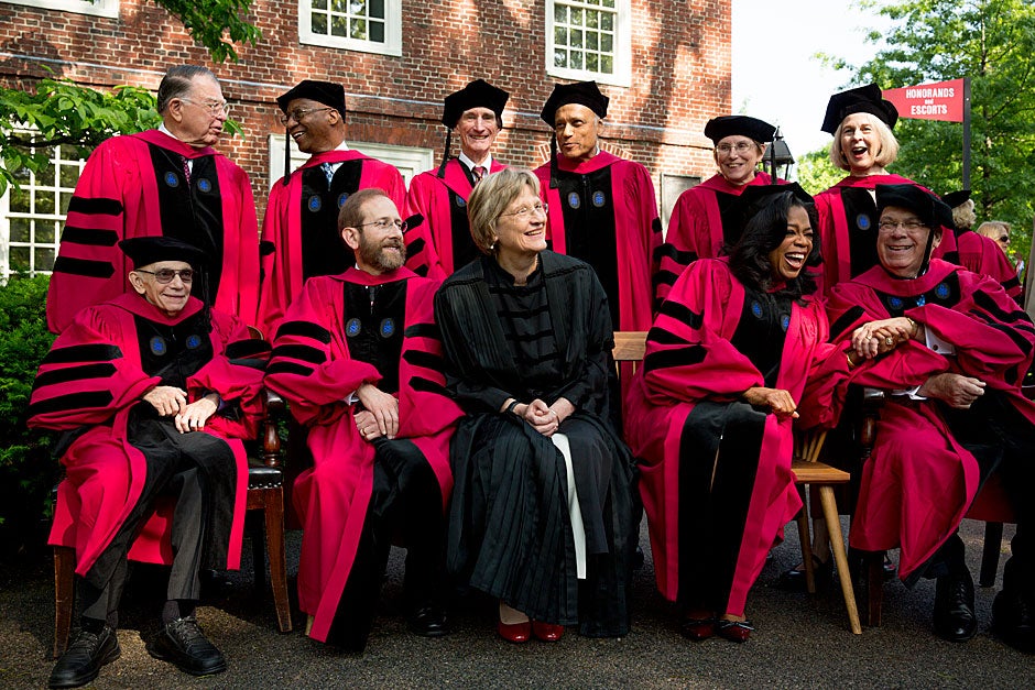 Honorands pose for a photo outside Massachusetts Hall. Among them is, of course, Oprah Winfrey — and to her right, Thomas M. Menino, Boston’s longest-serving mayor. On the back row (from left) is C. Dixon Spangler Jr., Donald R. Hopkins, Lord May of Oxford, Sir Partha Dasgupta, JoAnne Stubbe, and Elaine Pagels. On the front row (from left) is Maestro Jose Antonio Abreu, Provost Alan M. Garber, President Drew Faust, Winfrey, and Menino. Stephanie Mitchell/Harvard Staff Photographer