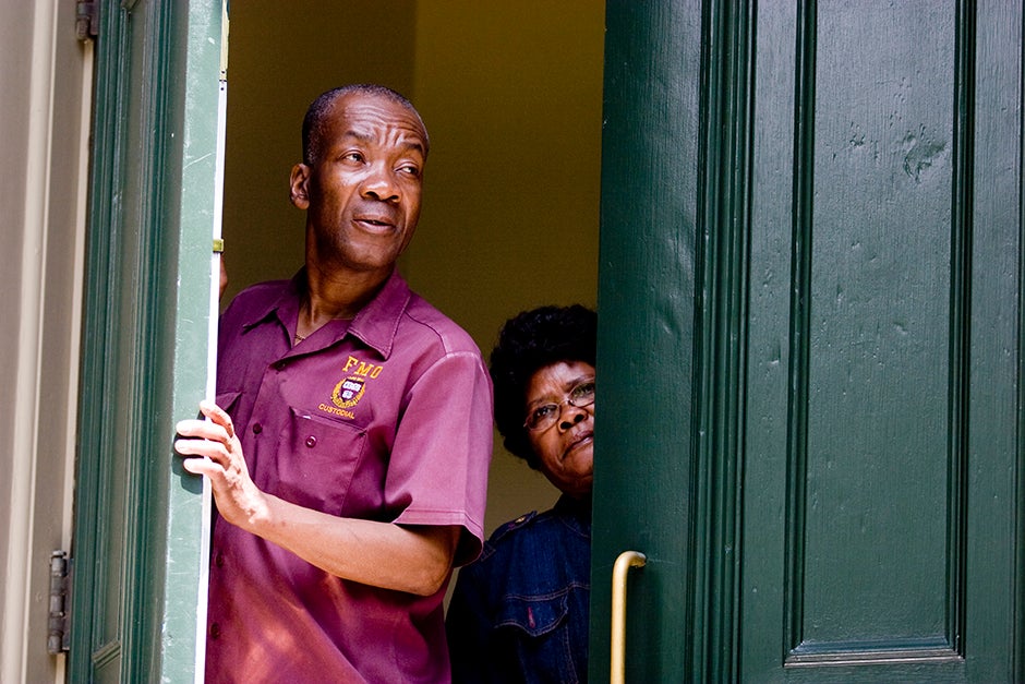 In 2009, Leonvil Altidor (from left) and Andree-Rose Saint-Cyr, custodians in Thayer Hall, watch the Baccalaureate Procession through Harvard Yard. Rose Lincoln/Harvard Staff Photographer