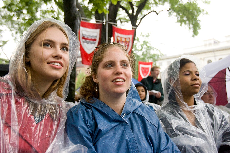 Laura Togut '08 (from left), Rory Sullivan '09, and Virginia Anderson '08 are cheerful despite the rain during the 2008 Senior Class Day exercises. Kris Snibbe/Harvard Staff Photographer