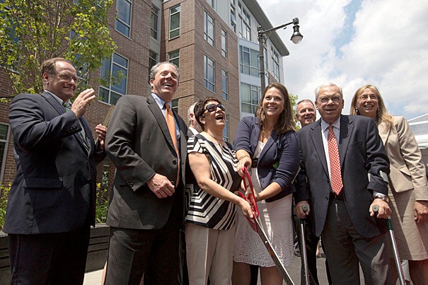 Congressman Michael E. Capuano (from left), Community Builders Inc. President and CEO Bart Mitchell, Charlesview resident Elsa Rojas, former Charlesview resident Angela Holm, Mayor Thomas M. Menino, and Housing and Urban Development Regional Administrator Barbara Fields cut the ribbon on the new Charlesview Residences at Brighton Mills. 