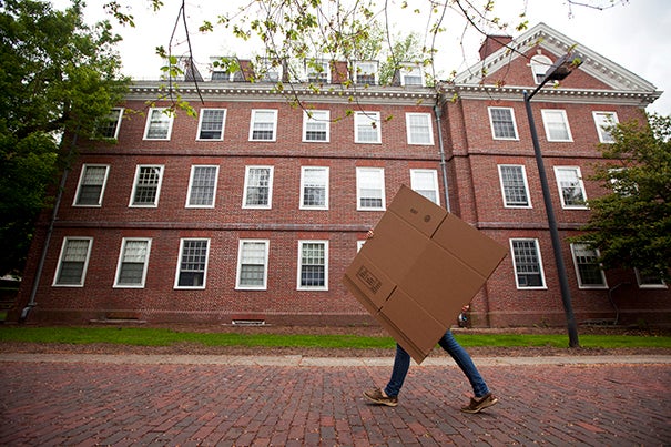 A student is eclipsed by a box while moving out from old Quincy House. Kris Snibbe/Harvard Staff Photographer
