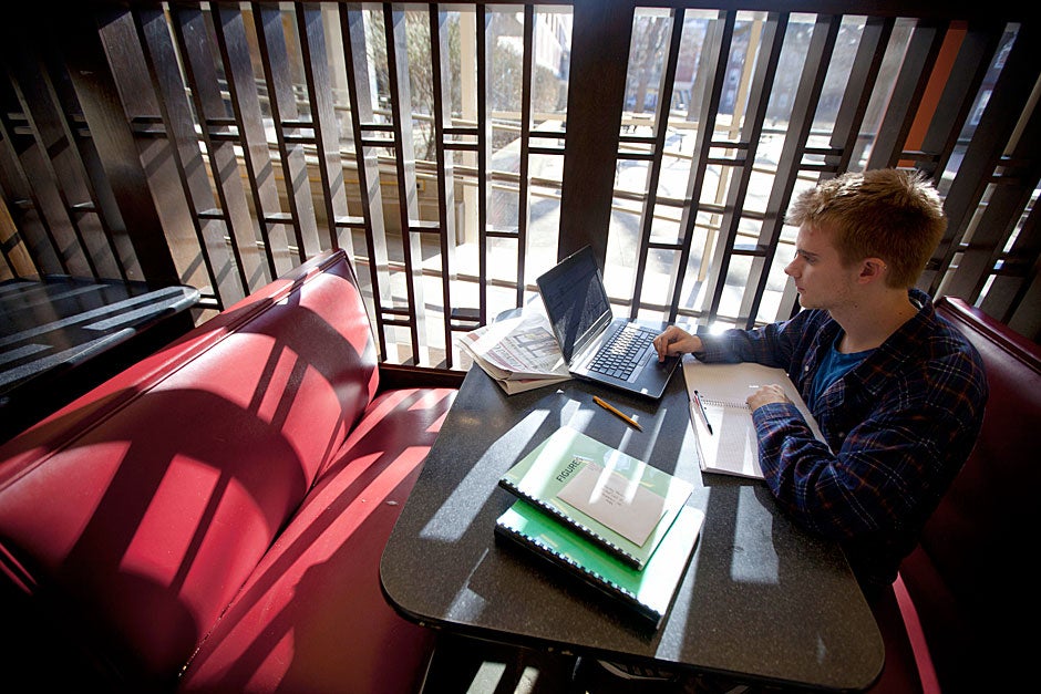 With light pouring through slats inside Quincy House, Kyle Rawding ’14 uses his laptop to study. Kris Snibbe/Harvard Staff Photographer