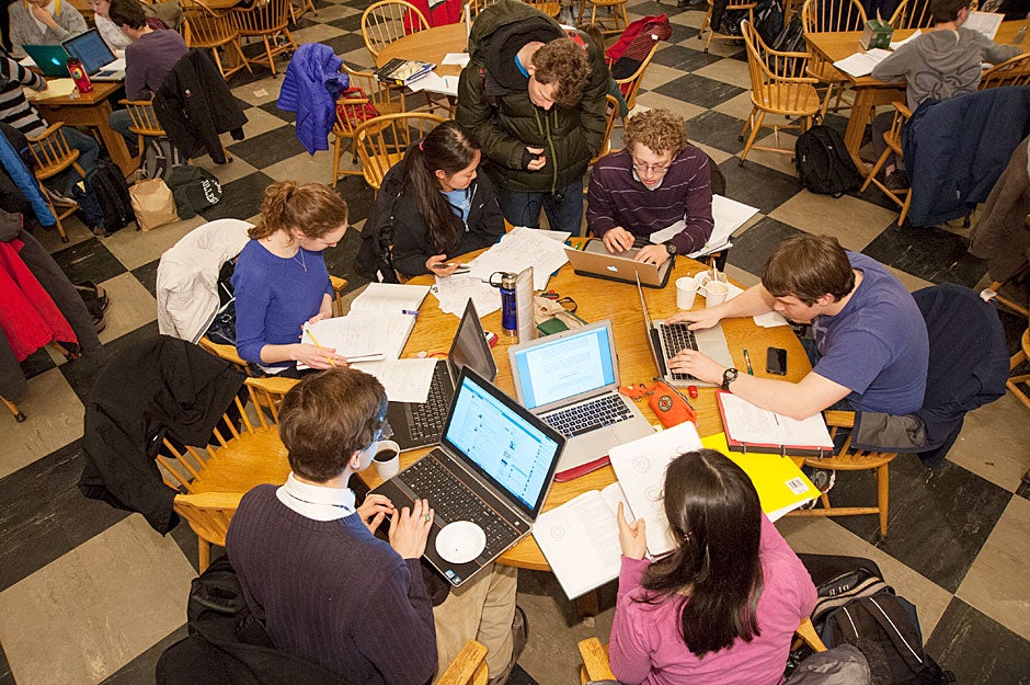 Students gather around tables in the dining room to confer on physics projects during Leverett House Physics Night. Jon Chase/Harvard Staff Photographer