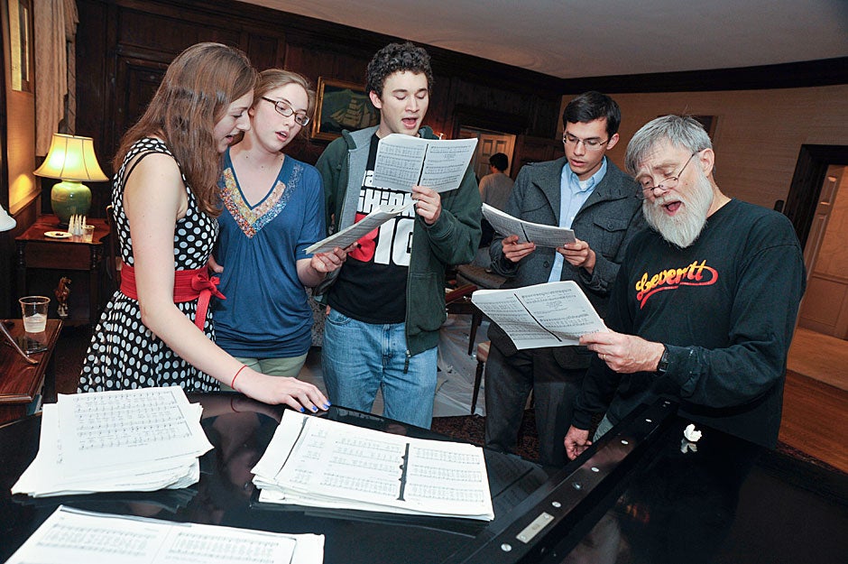 House Master Howard Georgi (right) joins student choristers for impromptu carols around the piano during the Leverett Open House. Jon Chase/Harvard Staff Photographer