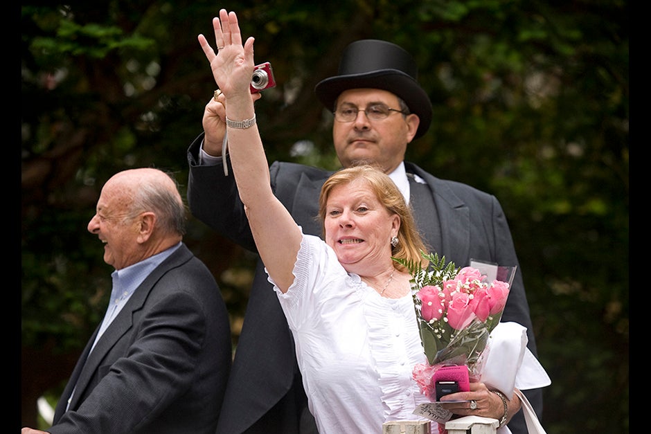 Marylynn Antonellis (center) tries desperately to attract the attention of her daughter Annie '09 outside Memorial Church, as husband Joe attempts a photo from behind his wife's outstretched hand. Jon Chase/Harvard Staff Photographer