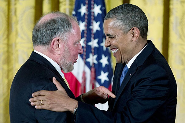 President Barack Obama laughs with Robert Putnam as he awards him the 2012  National Humanities Medal during a ceremony in the East Room of the White House on Wednesday. 