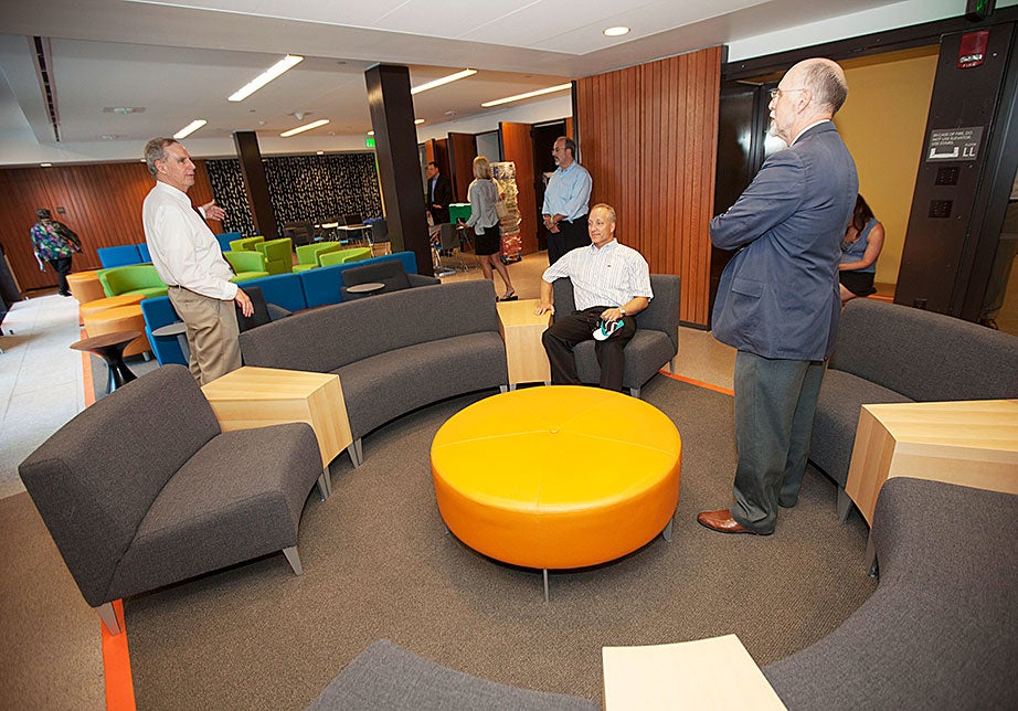 Faculty of Arts and Sciences Dean Michael D. Smith (center, seated) and interim Dean of Harvard College Donald Pfister (right, standing) are pictured in the new lower-level multipurpose room. 