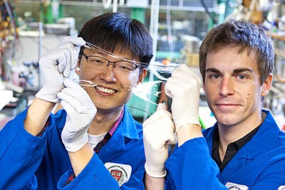 Jeong-Yun Sun (left) and Christoph Keplinger show off an ionically conductive material that is very stretchy and completely transparent. Eliza Grinnell/SEAS Communications