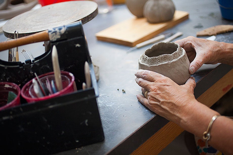 Emma Vesey decorates the surface of her hand-built pot.