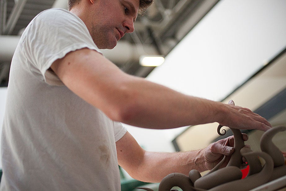 Christopher Adam ’94 fashions a ceramic sculpture by hand.
